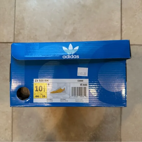 Men’s Adidas ZX 500 RM shoes in yellow.